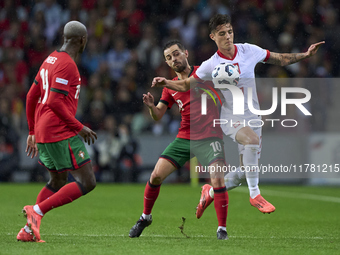 Bernardo Silva of Portugal competes for the ball with Kacper Urbanski of Poland during the UEFA Nations League 2024/25 League A Group A1 mat...