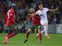 Bernardo Silva of Portugal competes for the ball with Kacper Urbanski of Poland during the UEFA Nations League 2024/25 League A Group A1 mat...