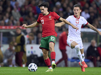 Kacper Urbanski of Poland competes for the ball with Vitor Ferreira 'Vitinha' of Portugal during the UEFA Nations League 2024/25 League A Gr...