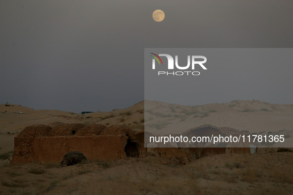 A photo taken in Oued Souf, Algeria, on November 15, 2024, shows a full moon during the 6th International Saharan Tourism Festival (FITS). O...