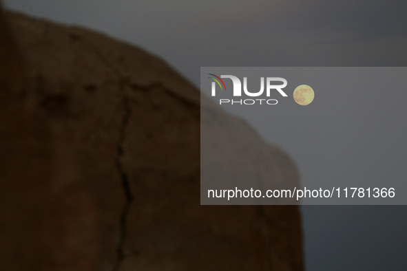 A photo taken in Oued Souf, Algeria, on November 15, 2024, shows a full moon during the 6th International Saharan Tourism Festival (FITS). O...