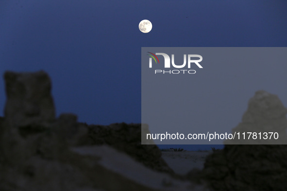 A photo taken in Oued Souf, Algeria, on November 15, 2024, shows a full moon during the 6th International Saharan Tourism Festival (FITS). O...