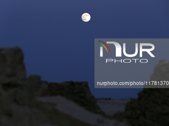 A photo taken in Oued Souf, Algeria, on November 15, 2024, shows a full moon during the 6th International Saharan Tourism Festival (FITS). O...