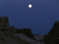 A photo taken in Oued Souf, Algeria, on November 15, 2024, shows a full moon during the 6th International Saharan Tourism Festival (FITS). O...