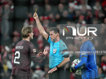 Joachim Andersen of Denmark  receives a yellow card during the Nations League Round 5 match between Denmark against Spain at Parken, Copenha...