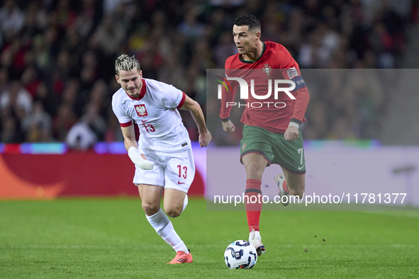 Cristiano Ronaldo of Portugal is challenged by Jakub Kaminski of Poland during the UEFA Nations League 2024/25 League A Group A1 match betwe...