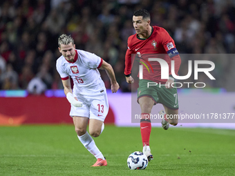 Cristiano Ronaldo of Portugal is challenged by Jakub Kaminski of Poland during the UEFA Nations League 2024/25 League A Group A1 match betwe...