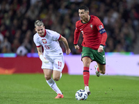 Cristiano Ronaldo of Portugal is challenged by Jakub Kaminski of Poland during the UEFA Nations League 2024/25 League A Group A1 match betwe...