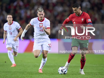 Cristiano Ronaldo of Portugal is challenged by Jakub Kaminski of Poland during the UEFA Nations League 2024/25 League A Group A1 match betwe...