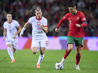 Cristiano Ronaldo of Portugal is challenged by Jakub Kaminski of Poland during the UEFA Nations League 2024/25 League A Group A1 match betwe...