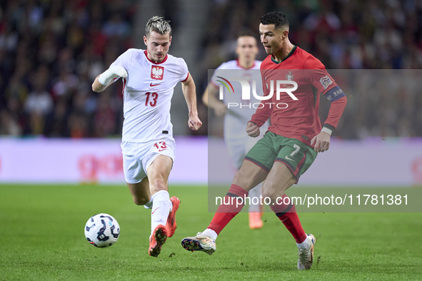 Cristiano Ronaldo of Portugal is challenged by Jakub Kaminski of Poland during the UEFA Nations League 2024/25 League A Group A1 match betwe...