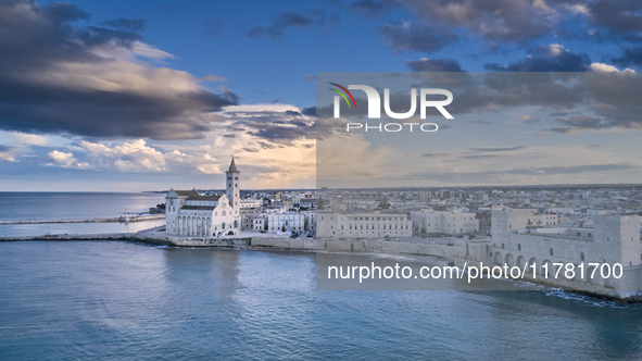 An aerial shot of the iconic Trani Cathedral, captured from the sea, highlights the Romanesque architecture of the cathedral, surrounded by...