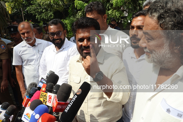 Sri Lankan President Anura Kumara Dissanayake shows his inked finger after casting his vote for the parliamentary election in Colombo, Sri L...