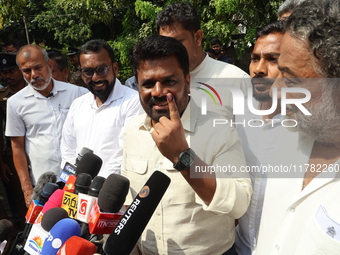 Sri Lankan President Anura Kumara Dissanayake shows his inked finger after casting his vote for the parliamentary election in Colombo, Sri L...