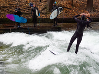 Surfers brave the icy waters of the Eisbach stream in Munich, Germany, on November 15, 2024. With temperatures at a brisk 5 degrees Celsius,...