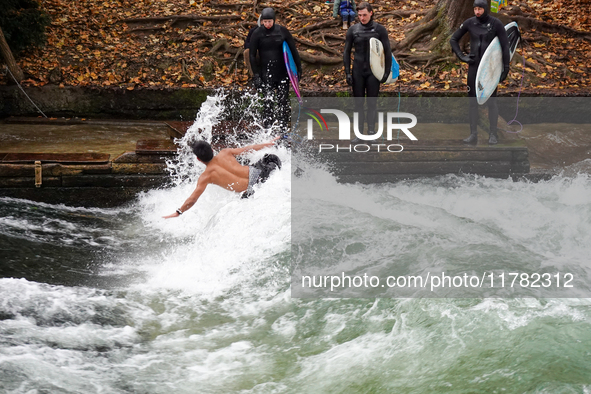 Surfers brave the icy waters of the Eisbach stream in Munich, Germany, on November 15, 2024. With temperatures at a brisk 5 degrees Celsius,...