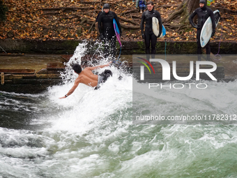 Surfers brave the icy waters of the Eisbach stream in Munich, Germany, on November 15, 2024. With temperatures at a brisk 5 degrees Celsius,...