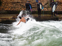 Surfers brave the icy waters of the Eisbach stream in Munich, Germany, on November 15, 2024. With temperatures at a brisk 5 degrees Celsius,...