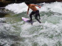 Surfers brave the icy waters of the Eisbach stream in Munich, Germany, on November 15, 2024. With temperatures at a brisk 5 degrees Celsius,...