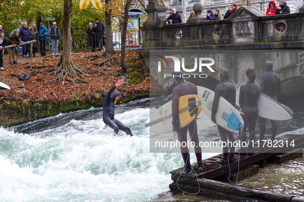 Surfers brave the icy waters of the Eisbach stream in Munich, Germany, on November 15, 2024. With temperatures at a brisk 5 degrees Celsius,...