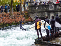 Surfers brave the icy waters of the Eisbach stream in Munich, Germany, on November 15, 2024. With temperatures at a brisk 5 degrees Celsius,...