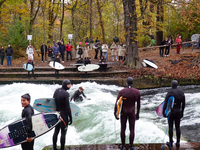 Surfers brave the icy waters of the Eisbach stream in Munich, Germany, on November 15, 2024. With temperatures at a brisk 5 degrees Celsius,...