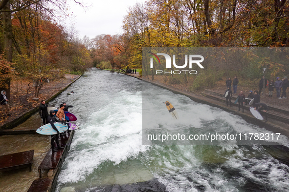 Surfers brave the icy waters of the Eisbach stream in Munich, Germany, on November 15, 2024. With temperatures at a brisk 5 degrees Celsius,...