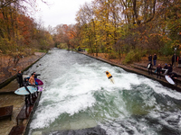 Surfers brave the icy waters of the Eisbach stream in Munich, Germany, on November 15, 2024. With temperatures at a brisk 5 degrees Celsius,...