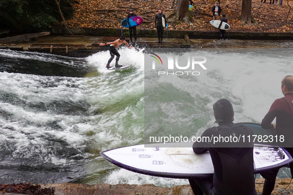 Surfers brave the icy waters of the Eisbach stream in Munich, Germany, on November 15, 2024. With temperatures at a brisk 5 degrees Celsius,...