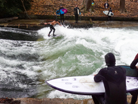 Surfers brave the icy waters of the Eisbach stream in Munich, Germany, on November 15, 2024. With temperatures at a brisk 5 degrees Celsius,...