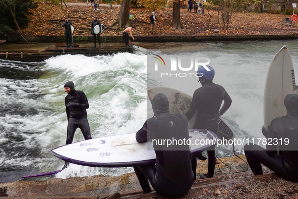 Surfers brave the icy waters of the Eisbach stream in Munich, Germany, on November 15, 2024. With temperatures at a brisk 5 degrees Celsius,...