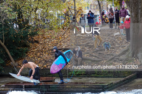 Surfers brave the icy waters of the Eisbach stream in Munich, Germany, on November 15, 2024. With temperatures at a brisk 5 degrees Celsius,...