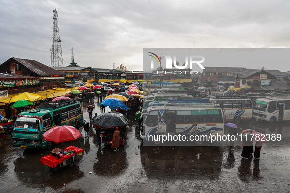 People use umbrellas as they walk amid heavy rainfall in Sopore, Jammu and Kashmir, India, on November 16, 2024. Higher reaches in Kashmir,...