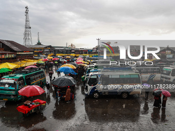 People use umbrellas as they walk amid heavy rainfall in Sopore, Jammu and Kashmir, India, on November 16, 2024. Higher reaches in Kashmir,...