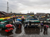 People use umbrellas as they walk amid heavy rainfall in Sopore, Jammu and Kashmir, India, on November 16, 2024. Higher reaches in Kashmir,...