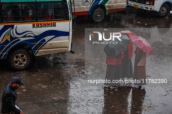 People use umbrellas as they walk amid heavy rainfall in Sopore, Jammu and Kashmir, India, on November 16, 2024. Higher reaches in Kashmir,...