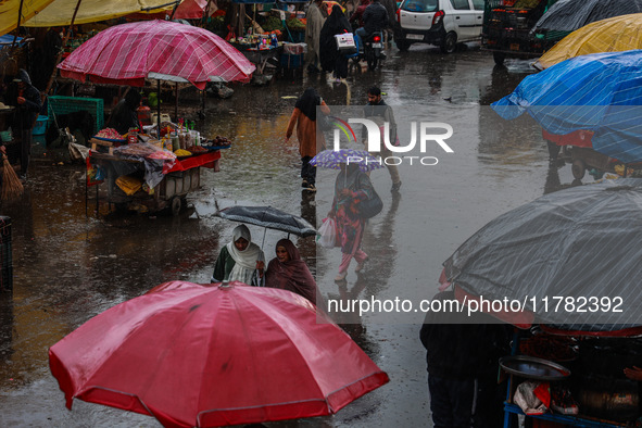 People use umbrellas as they walk amid heavy rainfall in Sopore, Jammu and Kashmir, India, on November 16, 2024. Higher reaches in Kashmir,...