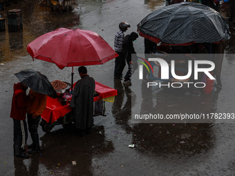 People use umbrellas as they walk amid heavy rainfall in Sopore, Jammu and Kashmir, India, on November 16, 2024. Higher reaches in Kashmir,...