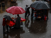 People use umbrellas as they walk amid heavy rainfall in Sopore, Jammu and Kashmir, India, on November 16, 2024. Higher reaches in Kashmir,...