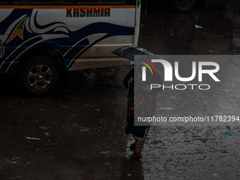 People use umbrellas as they walk amid heavy rainfall in Sopore, Jammu and Kashmir, India, on November 16, 2024. Higher reaches in Kashmir,...