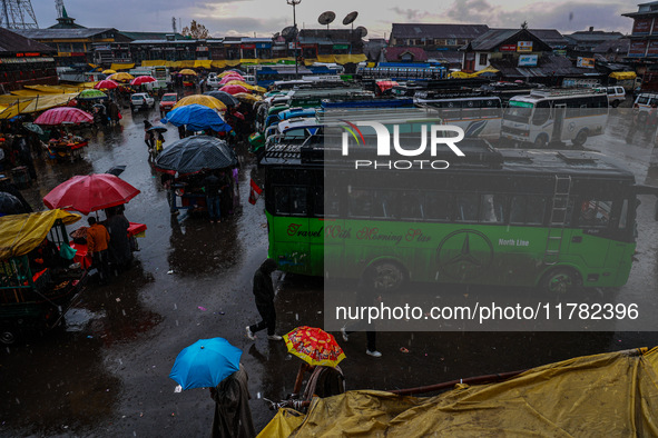 People use umbrellas as they walk amid heavy rainfall in Sopore, Jammu and Kashmir, India, on November 16, 2024. Higher reaches in Kashmir,...