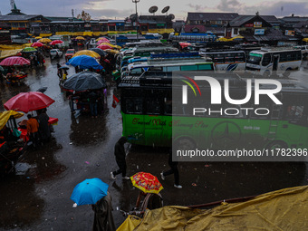 People use umbrellas as they walk amid heavy rainfall in Sopore, Jammu and Kashmir, India, on November 16, 2024. Higher reaches in Kashmir,...