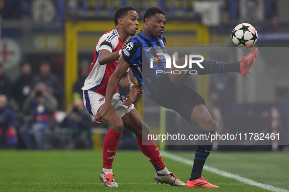 Denzel Dumfries of FC Internazionale competes for the ball with Jurrien Timber of Arsenal during the UEFA Champions League 2024/25 League Ph...