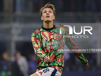 Martin Odegaard of Arsenal warms up before the UEFA Champions League 2024/25 League Phase MD4 match between FC Internazionale Milano and Ars...