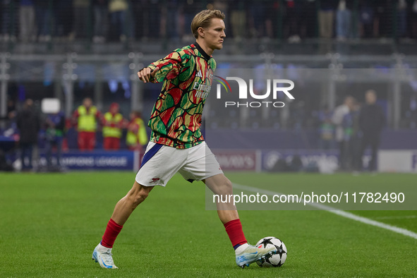 Martin Odegaard of Arsenal warms up before the UEFA Champions League 2024/25 League Phase MD4 match between FC Internazionale Milano and Ars...