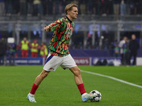 Martin Odegaard of Arsenal warms up before the UEFA Champions League 2024/25 League Phase MD4 match between FC Internazionale Milano and Ars...