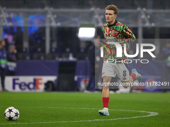 Martin Odegaard of Arsenal warms up before the UEFA Champions League 2024/25 League Phase MD4 match between FC Internazionale Milano and Ars...