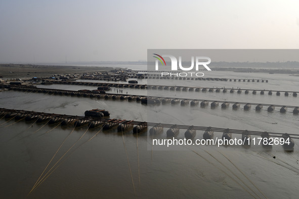 Labourers build a floating pontoon bridge across the river Ganges for devotees ahead of the upcoming Maha Kumbh 2025 festival in Prayagraj,...