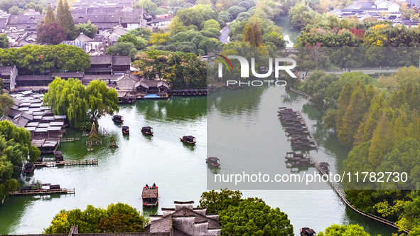 Tourists play at a scenic spot in Wuzhen, Zhejiang province, China, on November 16, 2024. 