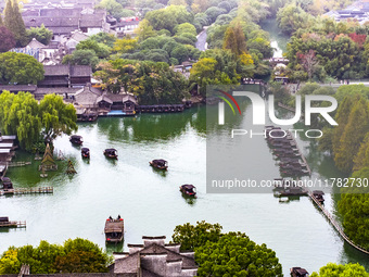 Tourists play at a scenic spot in Wuzhen, Zhejiang province, China, on November 16, 2024. (